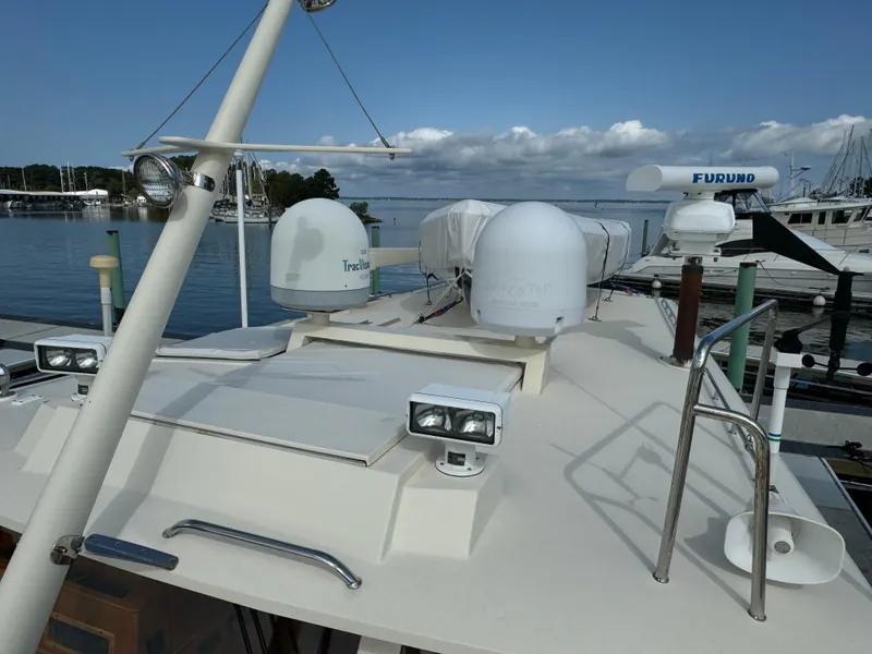 Slide: The Image of 2003 Dettling 51 Express Cruiser docked, featuring radar and navigation equipment on deck. - 22