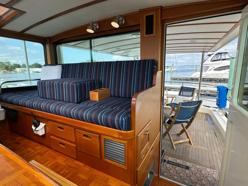 Slide: The Image of Interior of 2003 Dettling 51 Express Cruiser with striped seating and wooden cabinetry. - 27