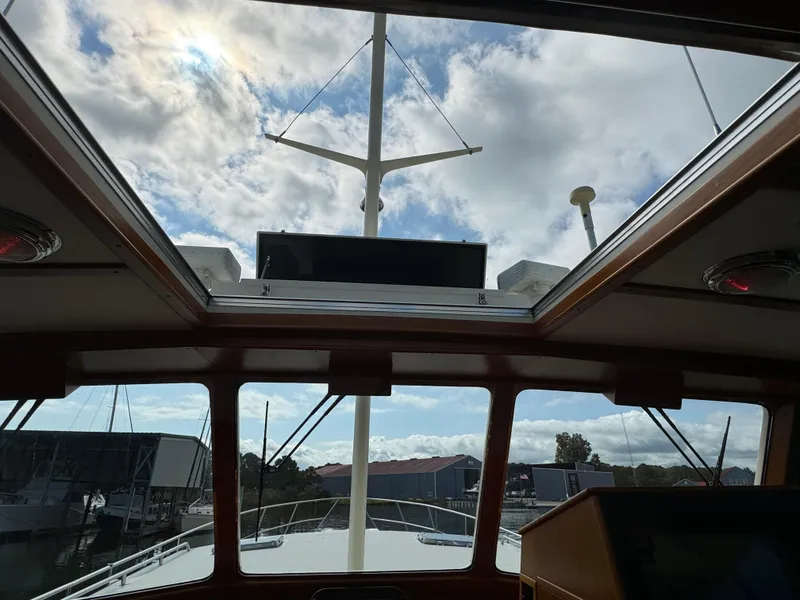 Slide: The Image of Interior view of 2003 Dettling 51 Express Cruiser with skylight and marina backdrop. - 28