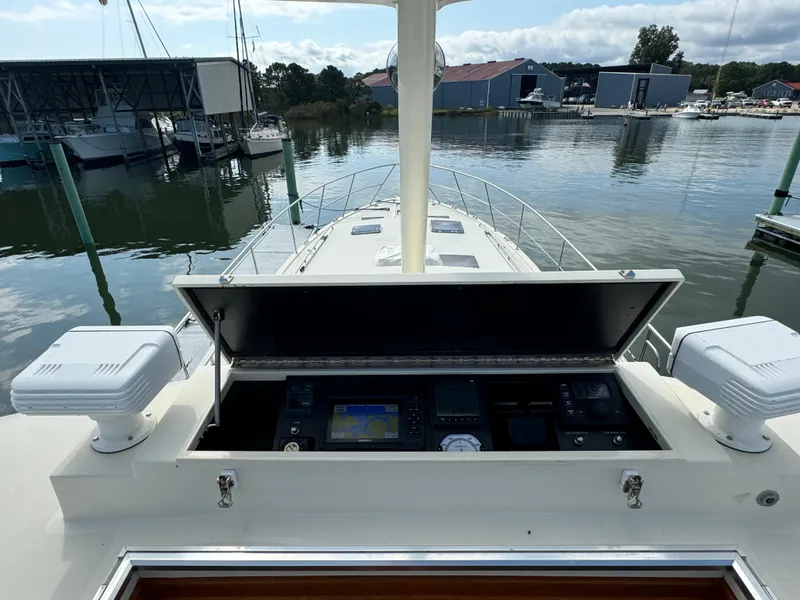 Slide: The Image of 2003 Dettling 51 Express Cruiser helm with navigation equipment, docked at a marina. - 29