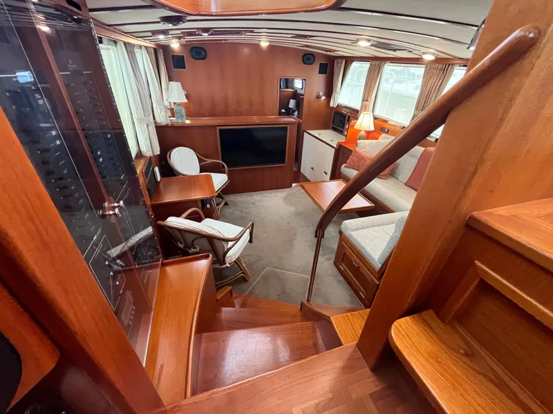 Slide: The Image of Interior of 2003 Dettling 51 Express Cruiser with wood finishes and cozy seating area. - 34