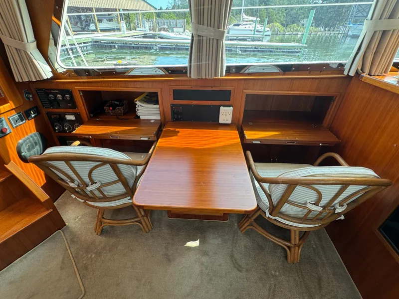 Slide: The Image of Interior of 2003 Dettling 51 Express Cruiser with wooden table and chairs. - 38