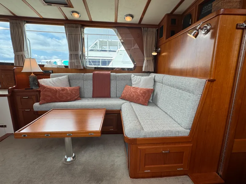 Slide: The Image of Interior of 2003 Dettling 51 Express Cruiser with cozy seating and wooden table. - 42