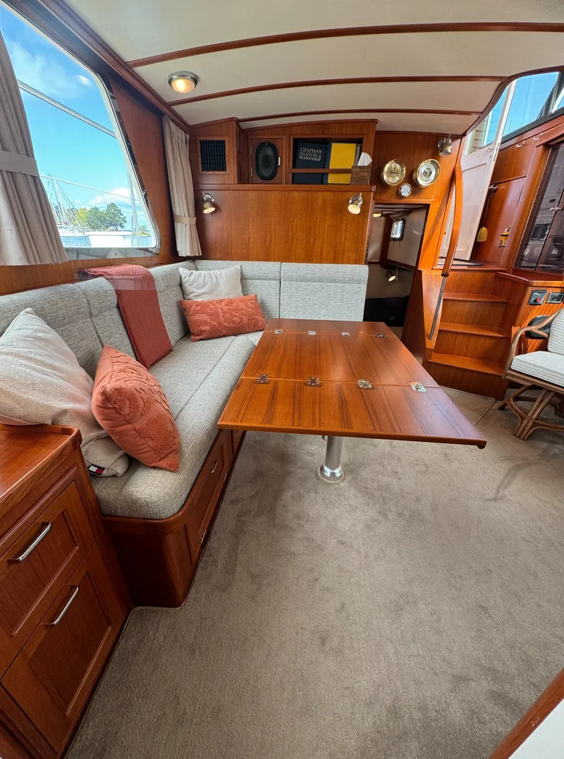 Slide: The Image of Interior of 2003 Dettling 51 Express Cruiser with cozy seating and wooden table. - 43