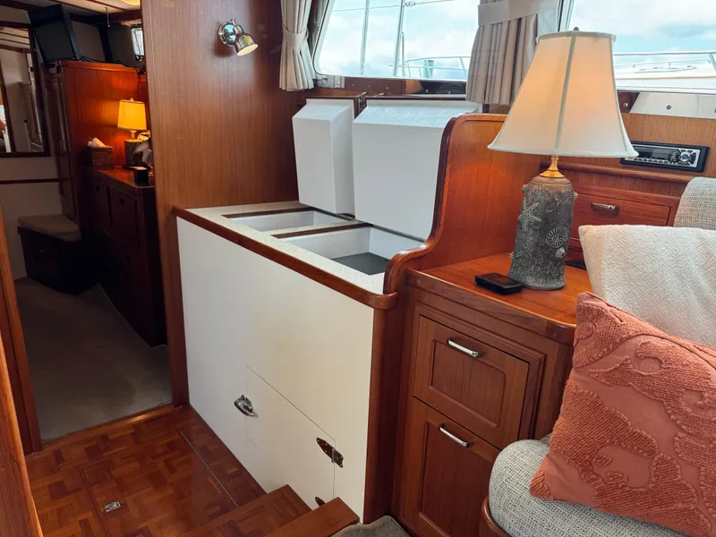 Slide: The Image of Interior of 2003 Dettling 51 Express Cruiser with wood paneling and cozy seating area. - 44