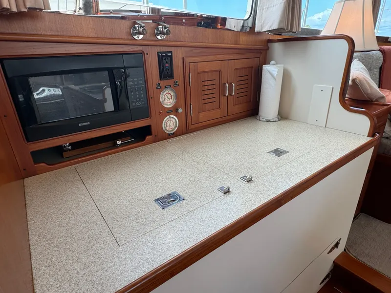 Slide: The Image of 2003 Dettling 51 Express Cruiser interior with microwave, wooden cabinets, and countertop. - 45