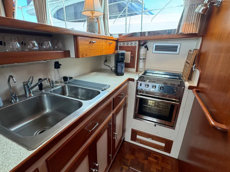 Slide: The Image of 2003 Dettling 51 Express Cruiser kitchen with stainless steel sink and modern appliances. - 46