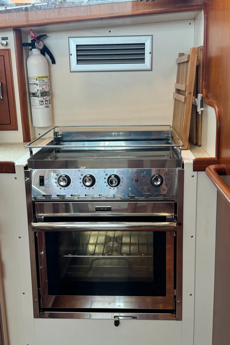 Slide: The Image of 2003 Dettling 51 Express Cruiser kitchen with stainless steel oven and fire extinguisher. - 47