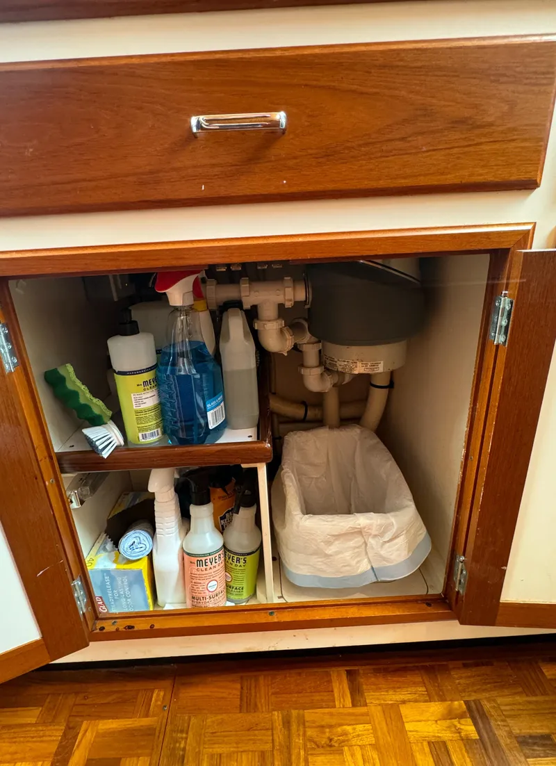 Slide: The Image of Under-sink cabinet with cleaning supplies on a 2003 Dettling 51 Express Cruiser. - 48