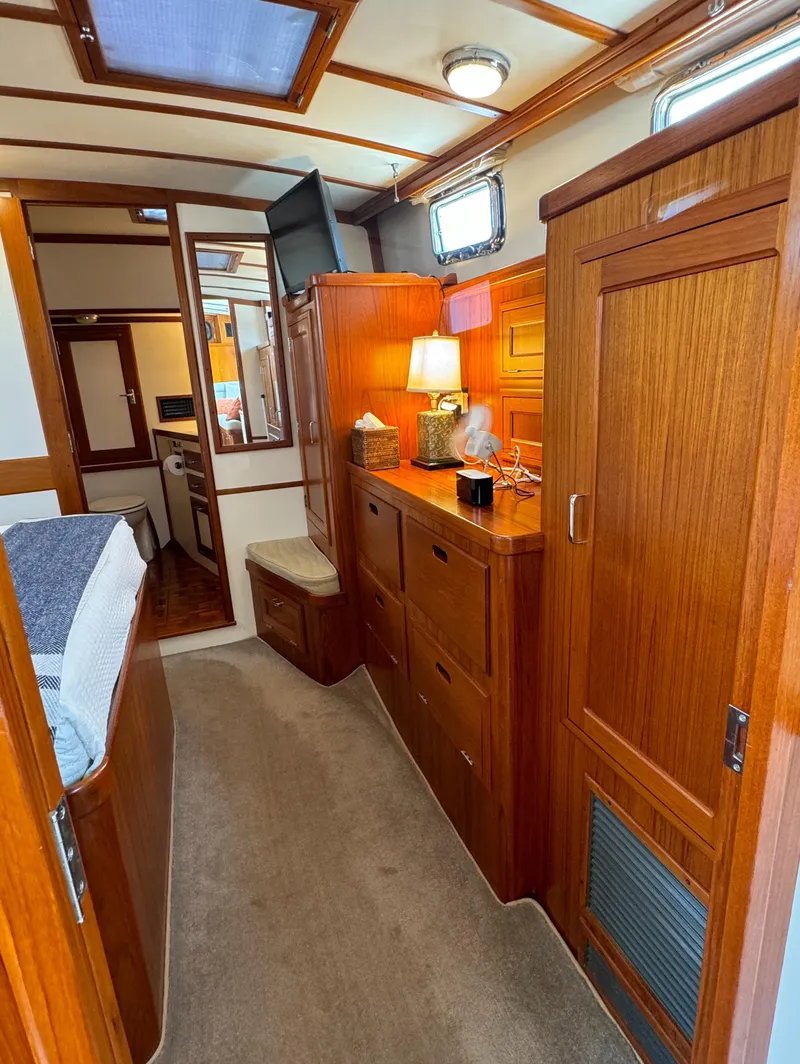 Slide: The Image of 2003 Dettling 51 Express Cruiser interior with wooden cabinetry and cozy lighting. - 49