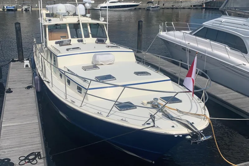 Slide: The Image of 2003 Dettling 51 Express Cruiser docked at marina, featuring sleek design and Canadian flag. - 5
