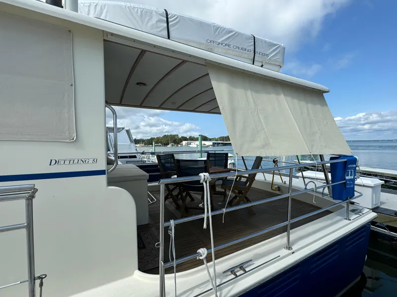 Slide: The Image of 2003 Dettling 51 Express Cruiser with covered deck, docked by the water. - 6
