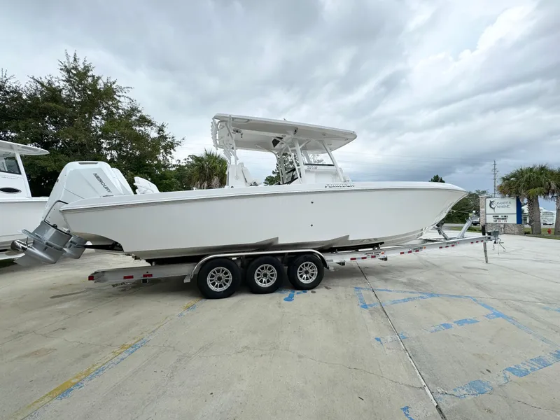 Slide: The Image of 2025 Fountain 34TE boat on trailer, parked outdoors under cloudy sky. - 11