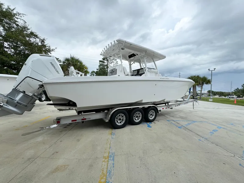 Slide: The Image of 2025 Fountain 34TE boat on a trailer in a parking lot. - 12