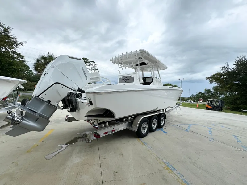 Slide: The Image of 2025 Fountain 34TE boat on a trailer, parked outdoors under cloudy skies. - 13