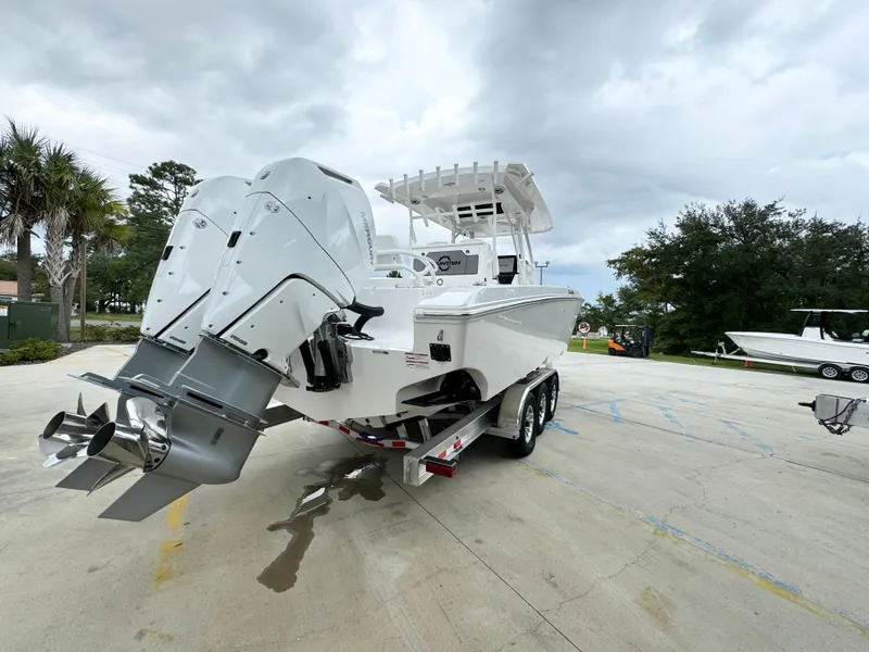Slide: The Image of 2025 Fountain 34TE boat with dual engines on a trailer, parked outdoors. - 14