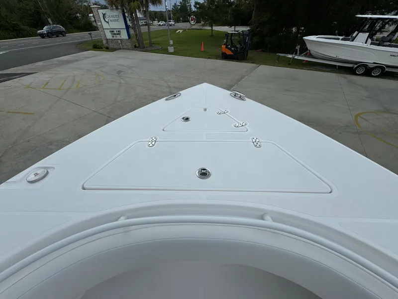 Slide: The Image of 2025 Fountain 34TE boat bow view in a marina setting. - 17