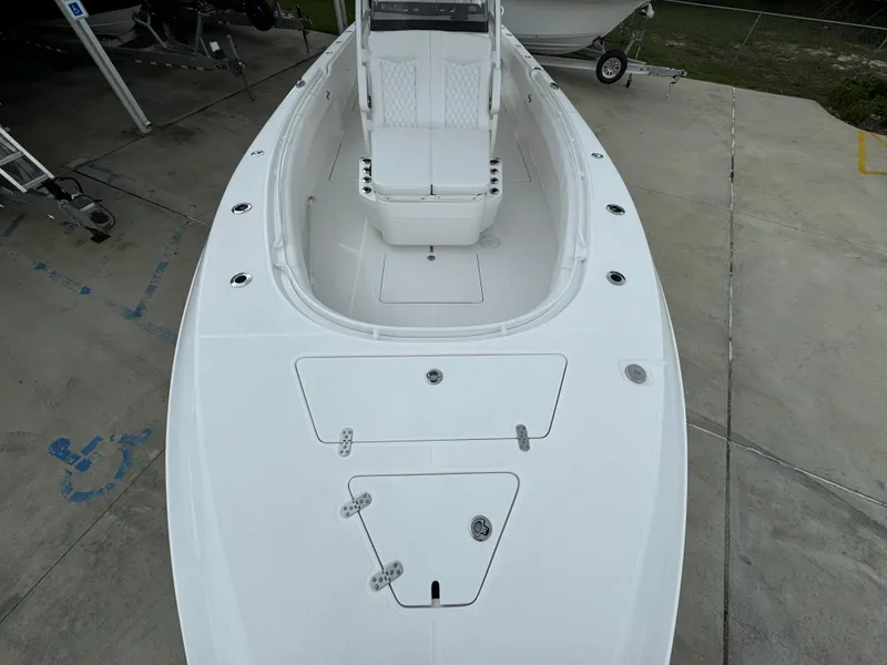 Slide: The Image of 2025 Fountain 34TE boat, white deck, spacious seating, docked on concrete surface. - 18