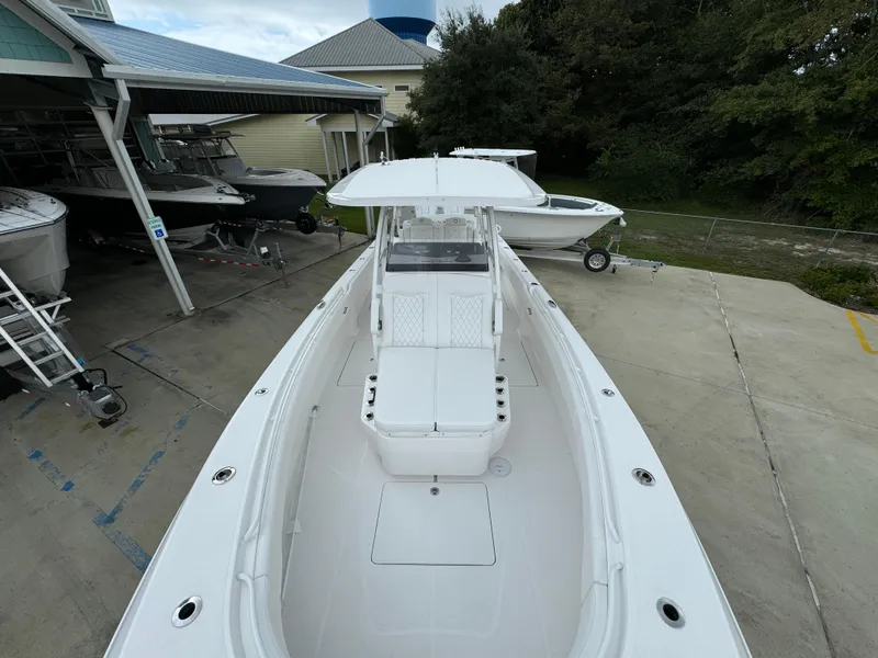 Slide: The Image of Fountain 34TE 2025 boat docked, showcasing sleek design and spacious deck. - 20