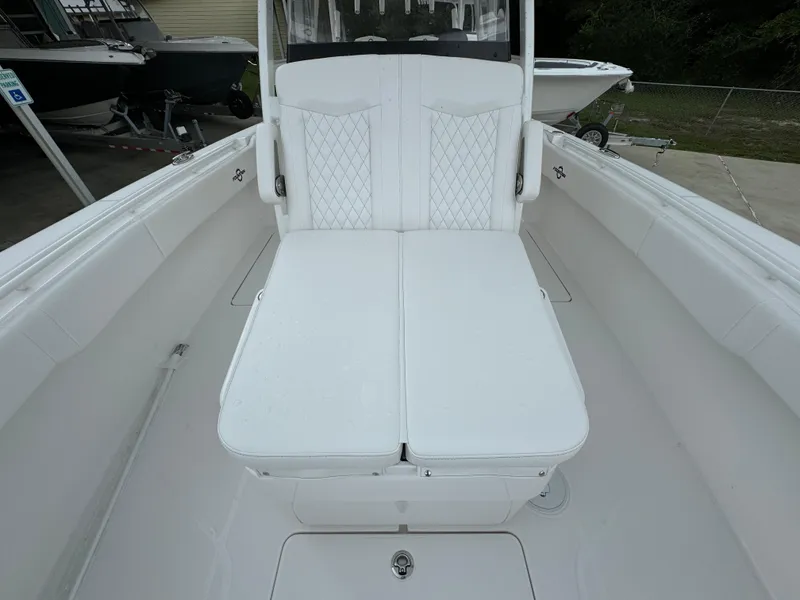 Slide: The Image of 2025 Fountain 34TE boat interior with white cushioned seating. - 21