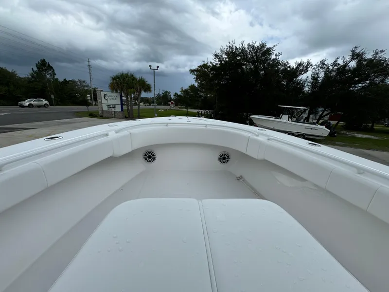 Slide: The Image of 2025 Fountain 34TE boat, white interior, parked outdoors under cloudy sky. - 22