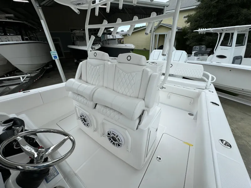 Slide: The Image of 2025 Fountain 34TE boat interior with white seating and steering wheel. - 28