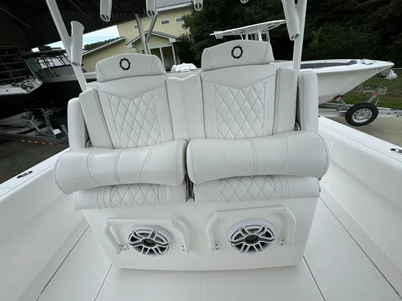 Slide: The Image of Luxury seating on 2025 Fountain 34TE boat with diamond stitching and built-in speakers. - 29