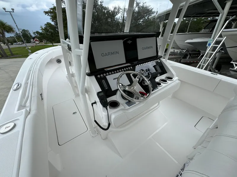 Slide: The Image of 2025 Fountain 34TE boat cockpit with Garmin navigation system and sleek white design. - 30