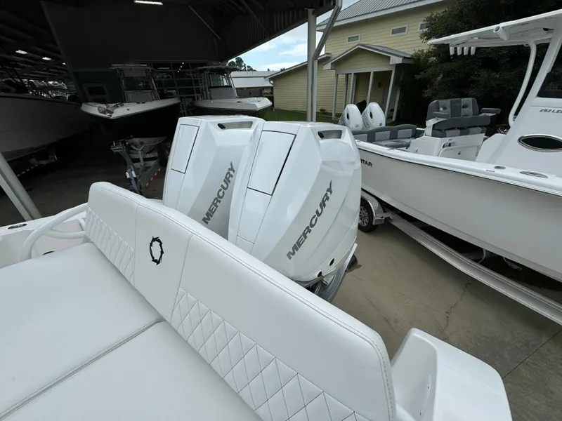 Slide: The Image of 2025 Fountain 34TE boat with dual Mercury outboard engines in a marina setting. - 36
