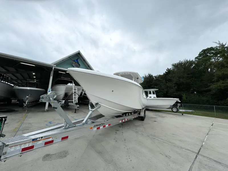 Slide: The Image of 2025 Fountain 34TE boat on trailer at marina, cloudy sky background. - 5