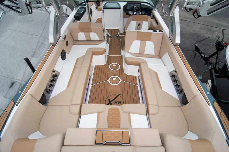 Slide: The Image of Luxurious 2025 MasterCraft X26 boat interior with tan and white seating. - 16