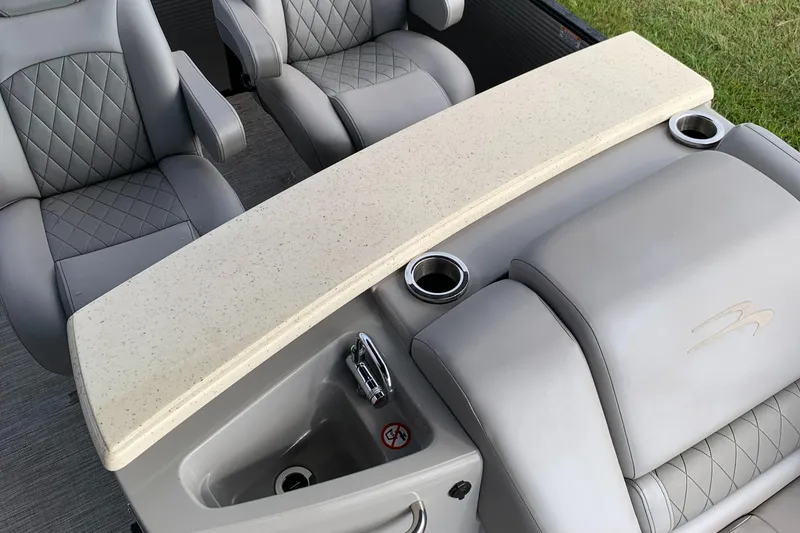 Slide: The Image of 2020 Bennington SXP 23 SBRXP boat interior with luxury seating and cup holders. - 6