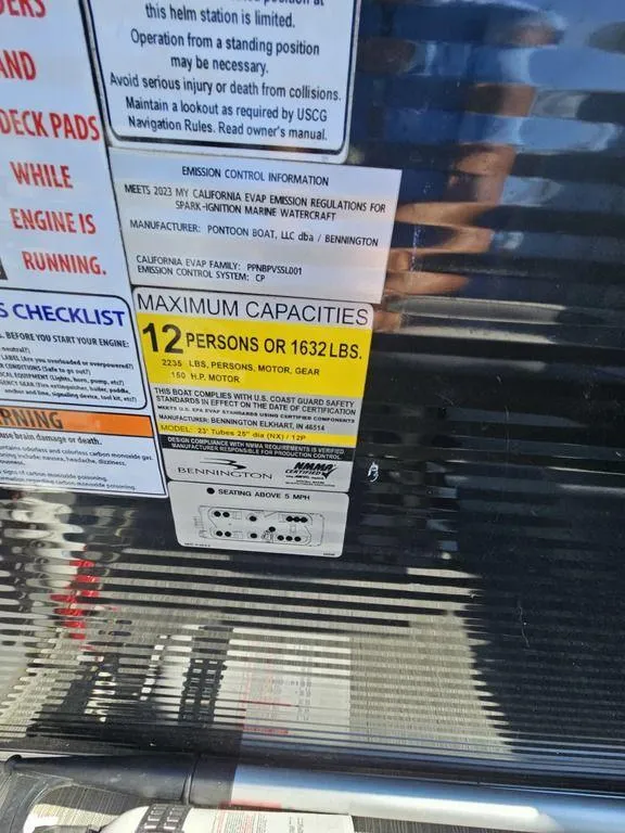 Slide: The Image of Capacity label on 2023 Bennington 24 SSR pontoon boat, showing 12-person or 1632 lbs limit. - 5