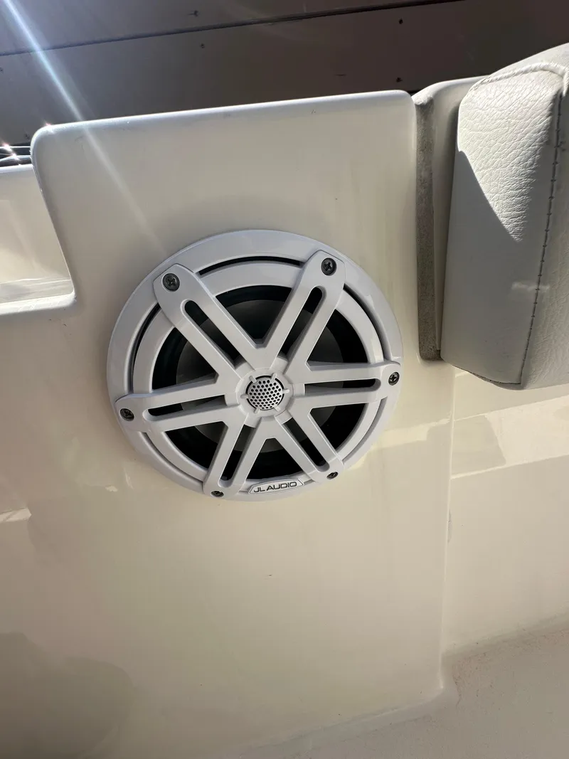 Slide: The Image of 2023 Cobia 220 Center Console boat speaker detail in sunlight. - 31