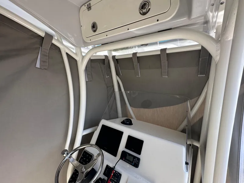 Slide: The Image of 2023 Cobia 220 Center Console boat interior with steering wheel and control panel. - 38