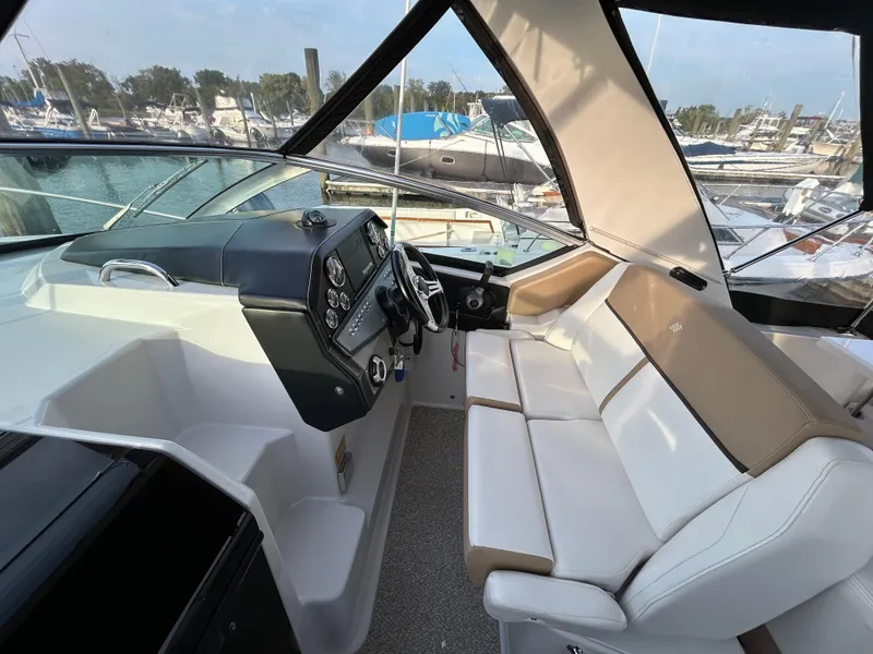Slide: The Image of 2014 Four Winns Vista 275 boat interior with helm and seating area. - 14