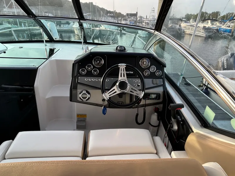 Slide: The Image of 2014 Four Winns Vista 275 boat cockpit with steering wheel and control panel. - 15