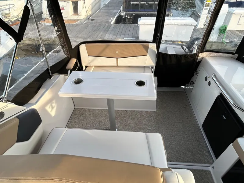Slide: The Image of Interior of a 2014 Four Winns Vista 275 boat with seating and table. - 16
