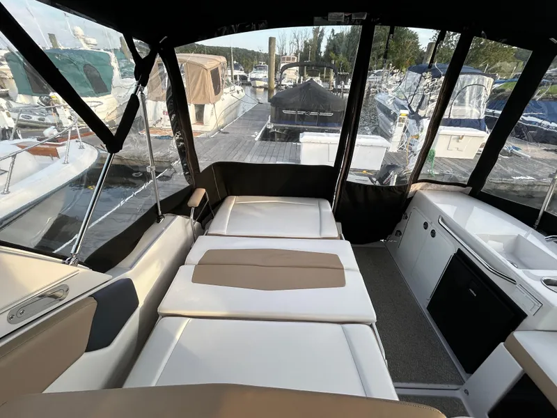 Slide: The Image of 2014 Four Winns Vista 275 interior with seating and marina view. - 18