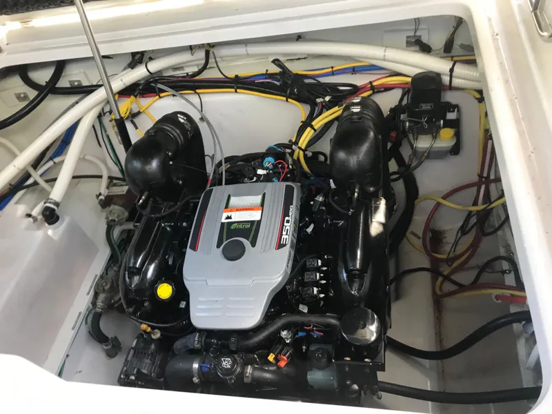 Slide: The Image of Engine compartment of 2014 Four Winns Vista 275 boat, showcasing a powerful engine setup. - 27