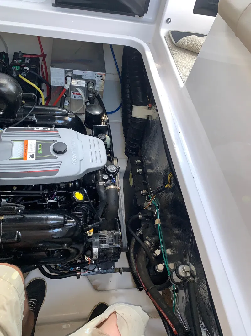 Slide: The Image of Engine compartment of 2014 Four Winns Vista 275 boat, showcasing mechanical components. - 28