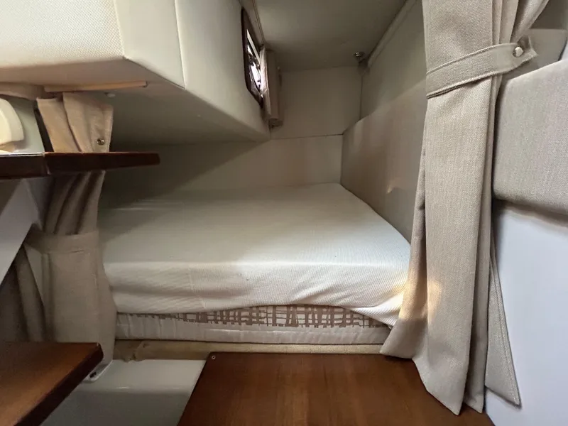 Slide: The Image of 2014 Four Winns Vista 275 cabin interior with cozy bed and curtains. - 8