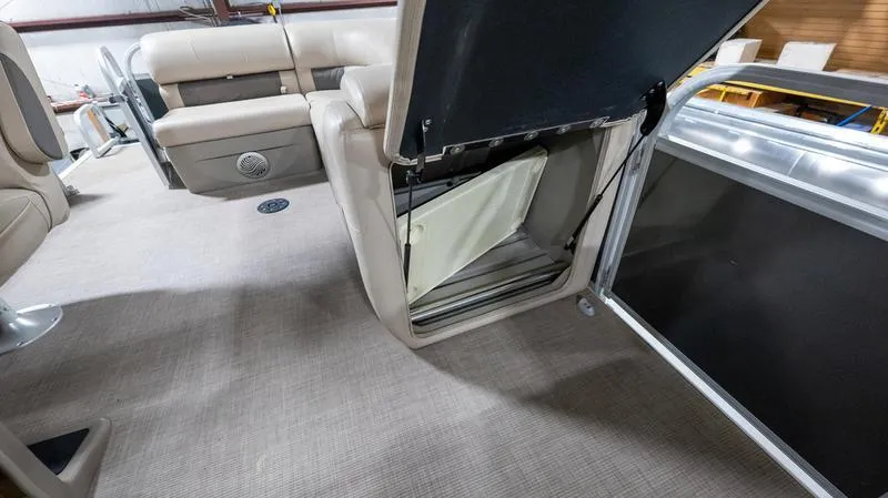 Slide: The Image of 2021 Sun Tracker Party Barge 20 DLX interior with open storage compartment. - 12