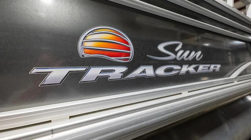 Slide: The Image of 2021 Sun Tracker Party Barge 20 DLX logo on metallic surface. - 14