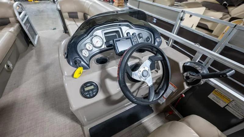 Slide: The Image of 2021 Sun Tracker Party Barge 20 DLX dashboard with steering wheel and controls. - 16