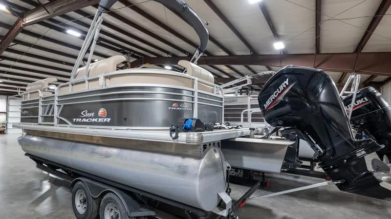 Slide: The Image of 2021 Sun Tracker Party Barge 20 DLX pontoon boat with Mercury engine in a warehouse. - 18