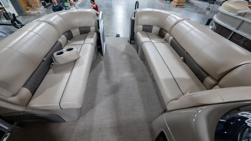 Slide: The Image of 2021 Sun Tracker Party Barge 20 DLX interior with beige seating and cup holders. - 3