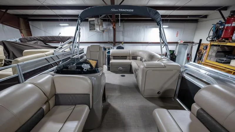 Slide: The Image of 2021 Sun Tracker Party Barge 20 DLX pontoon boat with spacious seating in a storage facility. - 4