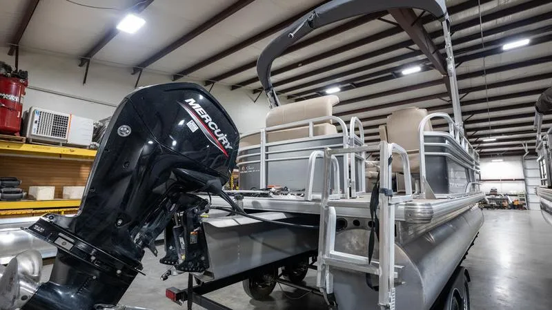 Slide: The Image of 2021 Sun Tracker Party Barge 20 DLX pontoon boat with Mercury outboard in a warehouse. - 5