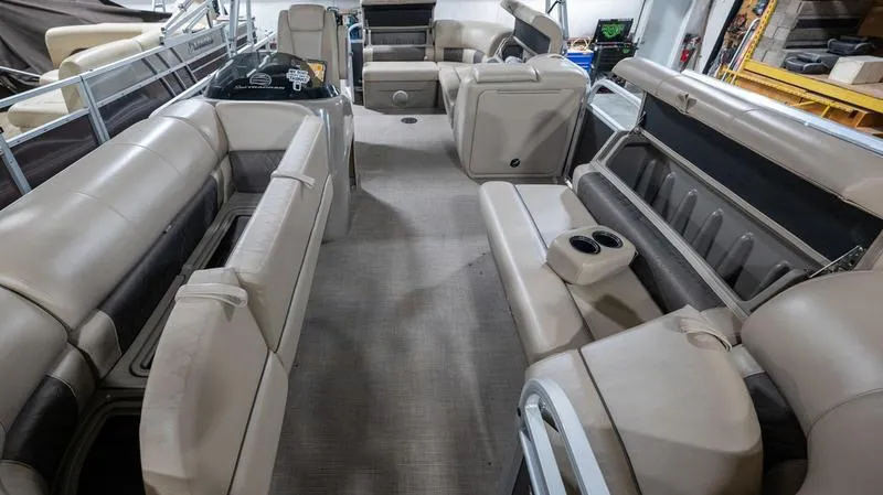 Slide: The Image of 2021 Sun Tracker Party Barge 20 DLX interior with spacious seating and cup holders. - 8